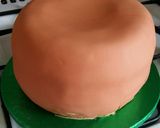 A picture of step 11 of Vickys Halloween Pumpkin Piñata Cake, Decorating Idea.