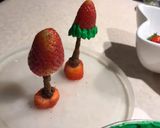 A picture of step 3 of Strawberry Santas 🎅 🌲.