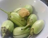 A picture of step 1 of Brinjal Curry in white gravy.