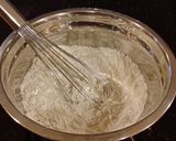 A picture of step 3 of Toasted Coconut Thumbprint Cookies.