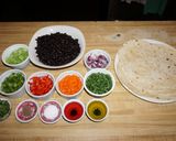 A picture of step 1 of FRIED TORTILLA HATS WITH BLACK BEAN SALAD AND GARLIC SHRIMP, JON STYLE.