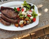 A picture of step 5 of Sirloin Steaks with fried baby potatoes & a greek salad.