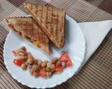 A picture of step 5 of Grilled sandwich filled with hummus, red sauce and vegetables.