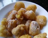 A picture of step 3 of Sweet Banana fritters with dusting of icing sugar n cinnamon.