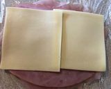 A picture of step 7 of Rolled smashed chicken with ham and cheese.