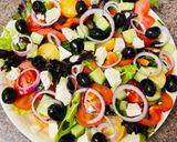 A picture of step 5 of Greek salad with shrimps.