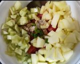 A picture of step 1 of Cucumber Apple and Tomato Salad.